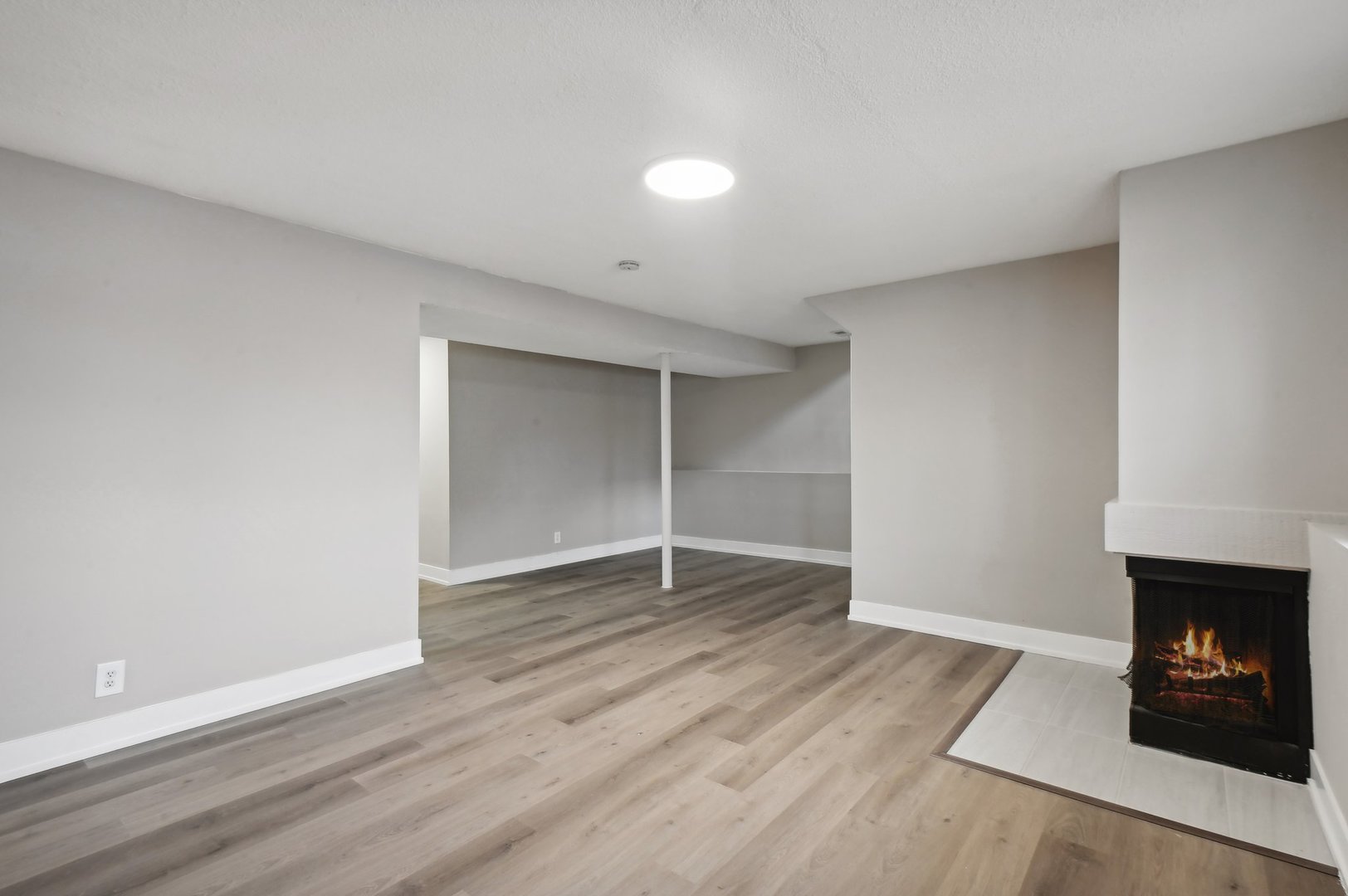 110 Elmwood Road Romeoville, IL 60446 - Photo 20 of 33 an empty room with wooden floor and fireplace