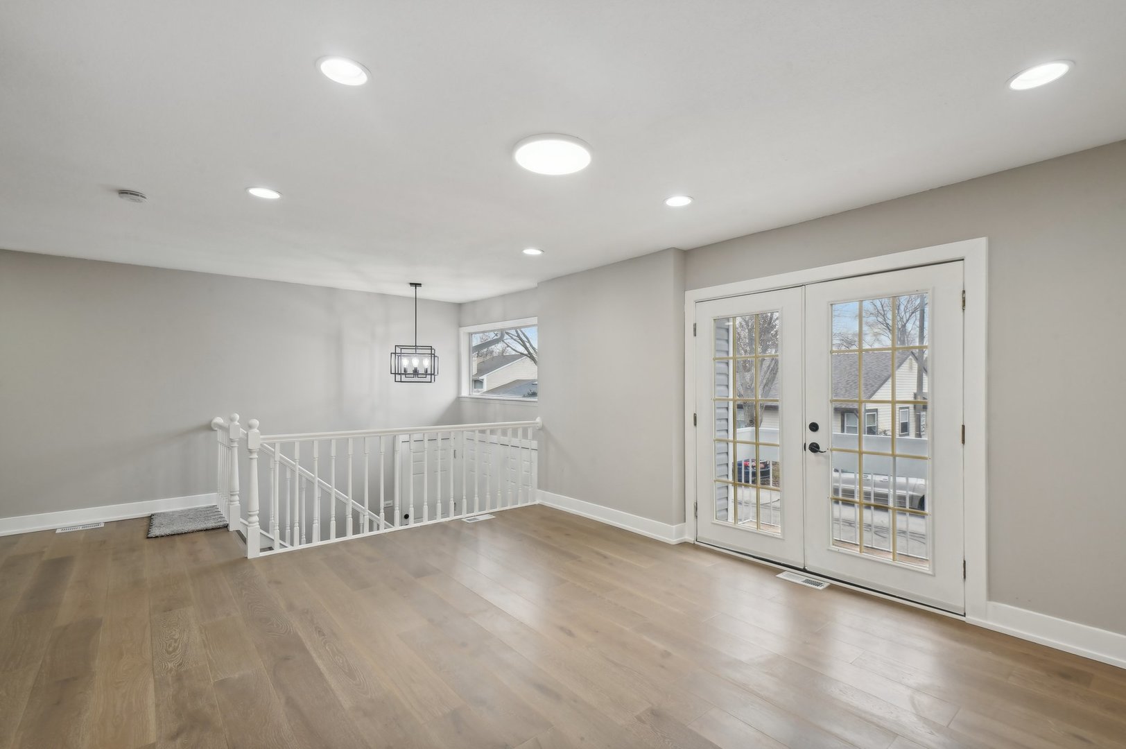 110 Elmwood Road Romeoville, IL 60446 - Photo 5 of 33 an empty room with wooden floor and windows