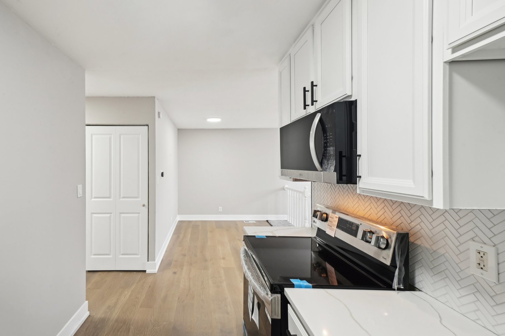 110 Elmwood Road Romeoville, IL 60446 - Photo 9 of 33 a kitchen with stainless steel appliances a stove and a microwave