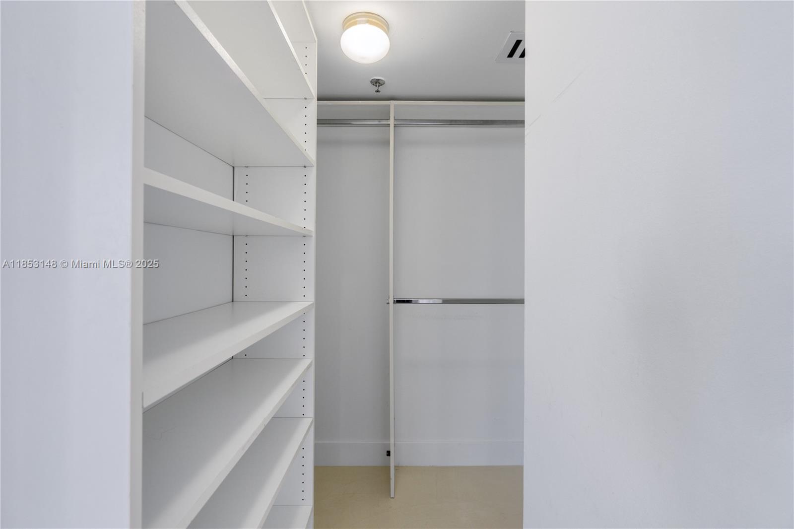 1621 Bay Road, Unit 602 Miami Beach, FL 33139 - Photo 14 of 32 a view of walk in closet with empty racks