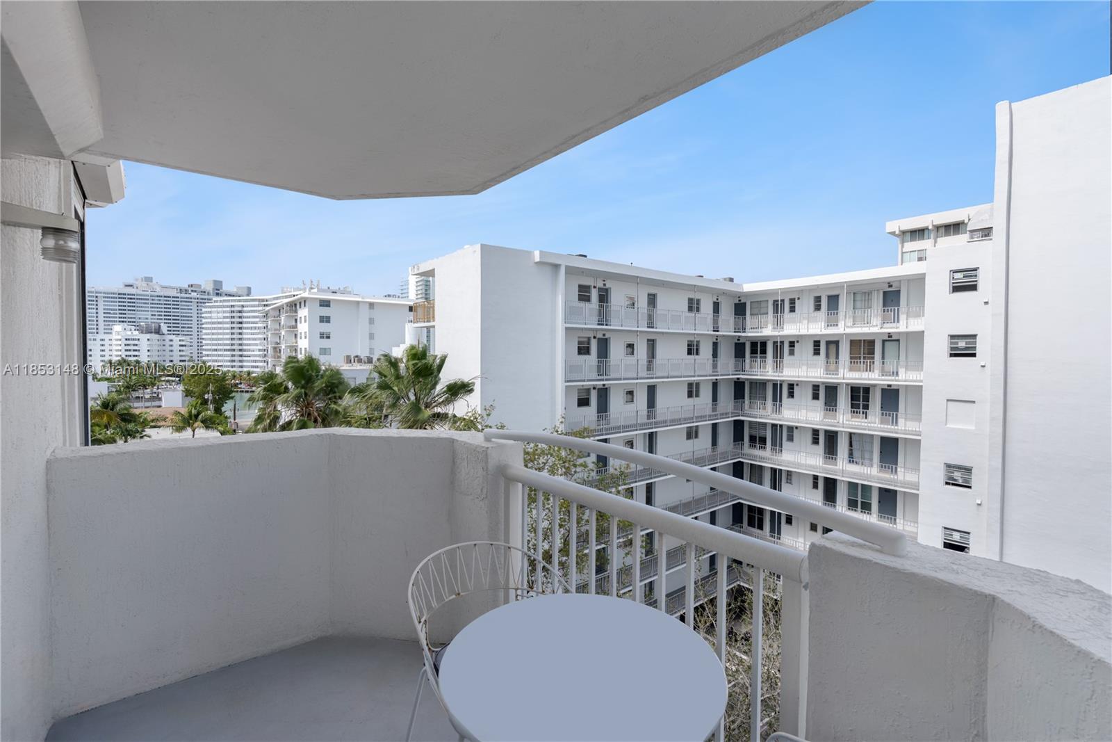1621 Bay Road, Unit 602 Miami Beach, FL 33139 - Photo 15 of 32 a view of a dining room with furniture and a floor to ceiling window
