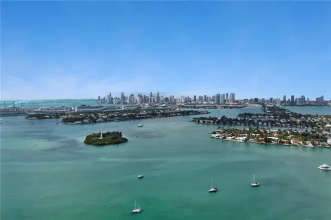 a view of a lake with boats and trees in the background
