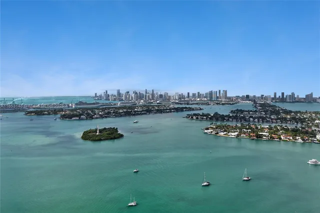 a view of a lake with boats and trees in the background