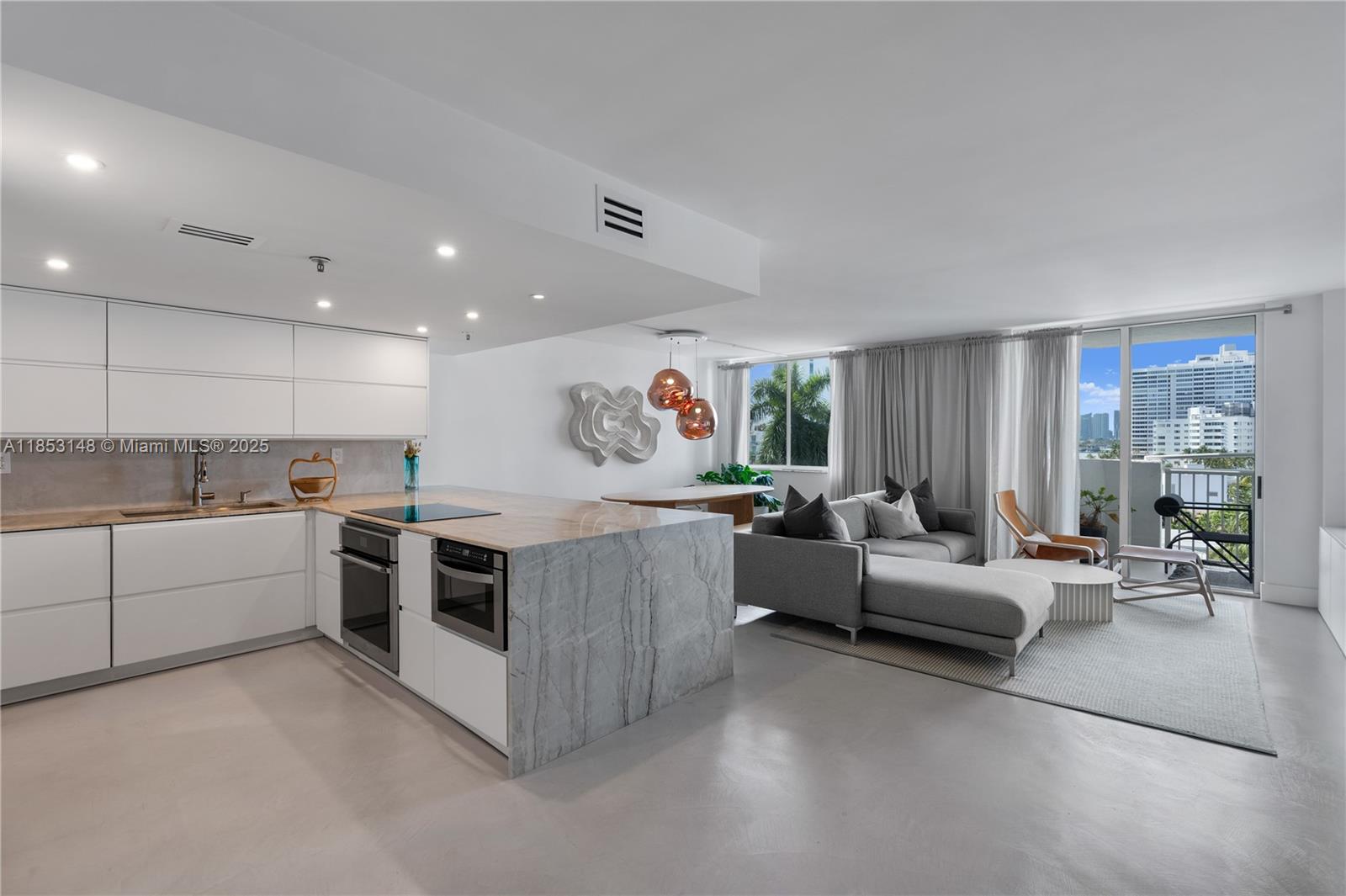 1621 Bay Road, Unit 602 Miami Beach, FL 33139 - Photo 5 of 32 a living room with furniture and a large window