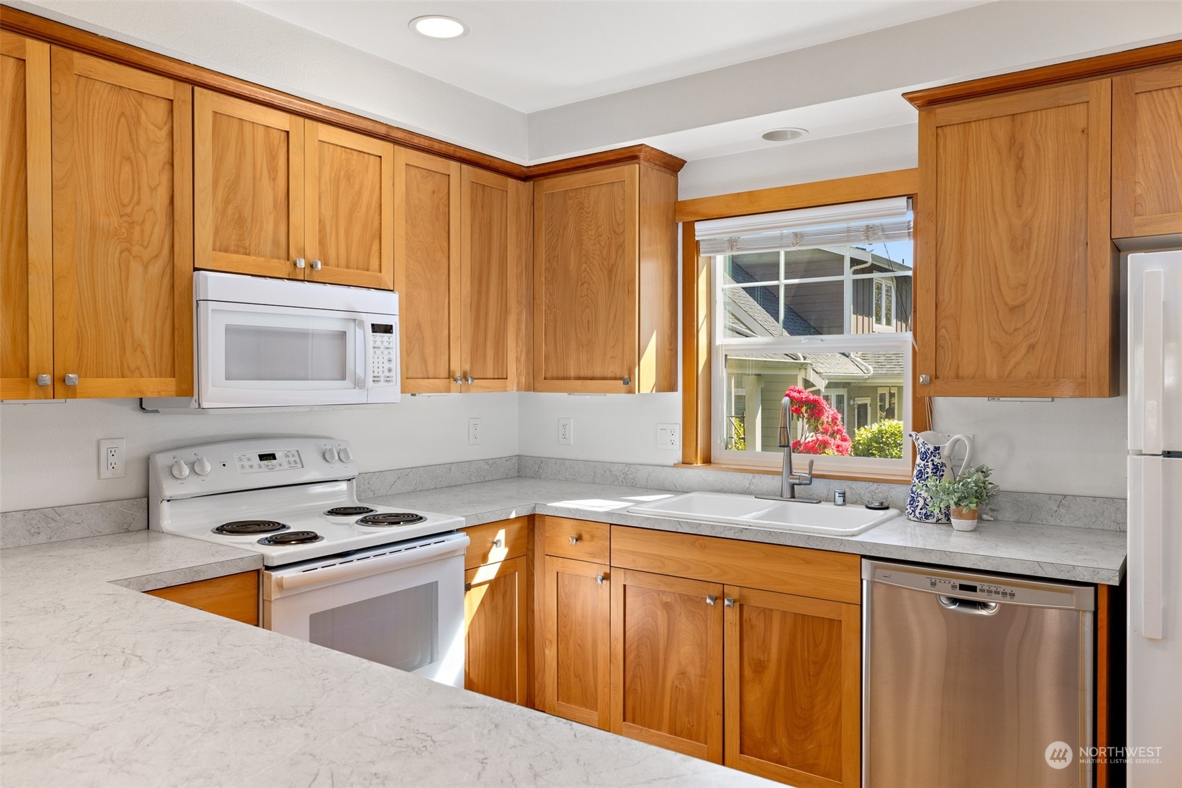 1322 Polly's Lane Bainbridge Island, WA 98110 - Photo 11 of 30 a kitchen with stainless steel appliances granite countertop a sink dishwasher stove and cabinets with wooden floor