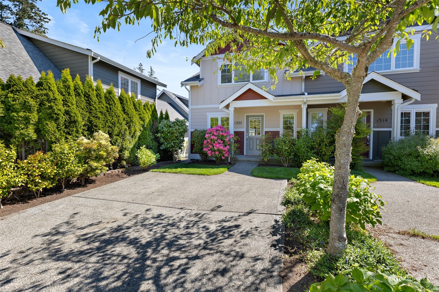 1322 Polly's Lane Bainbridge Island, WA 98110 - Photo 3 of 30 a front view of a house with a yard and potted plants