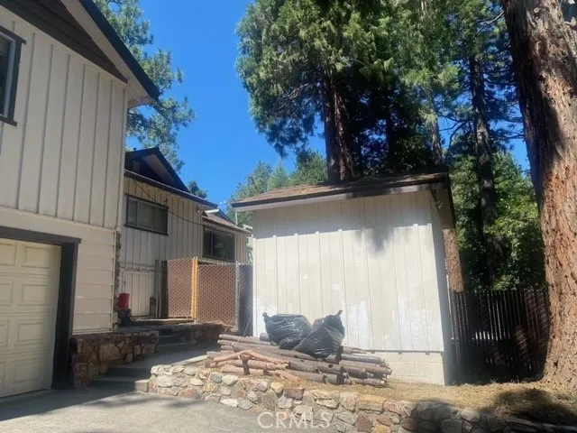 a view of a patio with a table and chairs under an umbrella