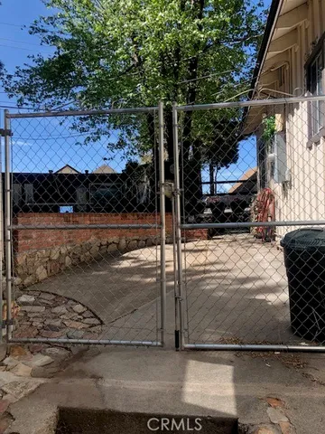 a view of a patio with a table and chairs with wooden floor and fence