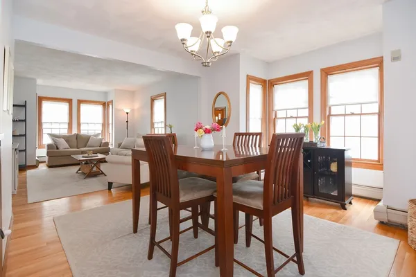 a view of a dining room with furniture window and wooden floor