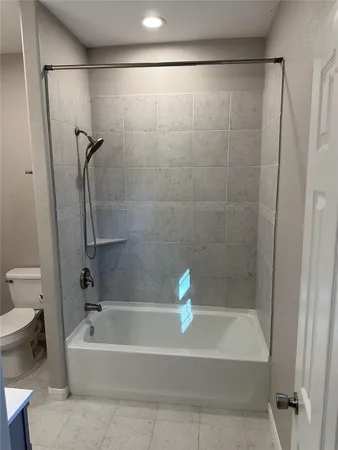 a bathroom with a shower and a bathtub
