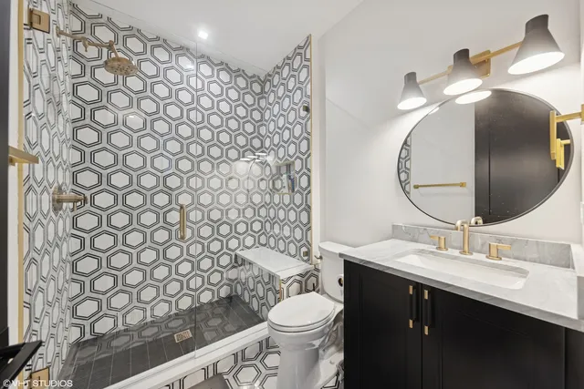 a bathroom with a sink toilet and a mirror