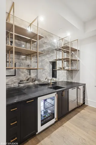 a kitchen with stainless steel appliances granite countertop a sink and wooden cabinets