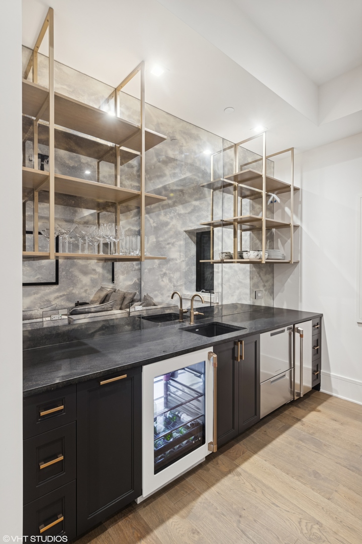 4320 Howard Avenue Western Springs, IL 60558 - Photo 10 of 20 a kitchen with stainless steel appliances granite countertop a sink and wooden cabinets