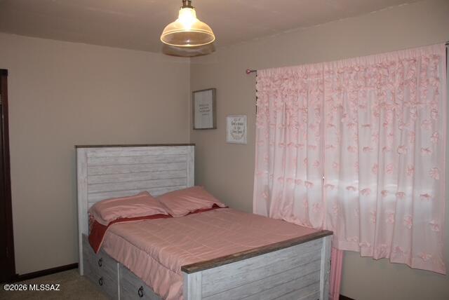 1201 East Old Stewart Road Willcox, AZ 85643 - Photo 30 of 49 a bedroom with a bed and a chandelier