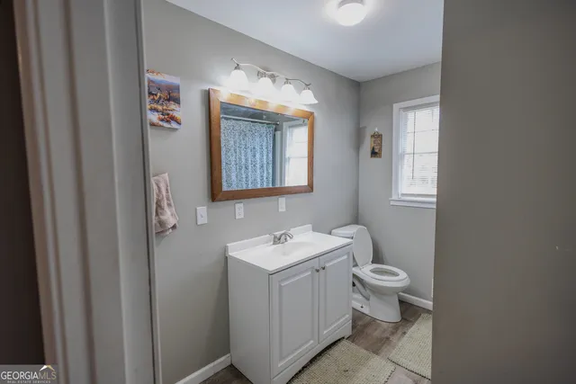 a white toilet sitting next to a shower curtain