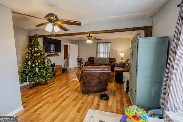 a view of entryway and hall with wooden floor