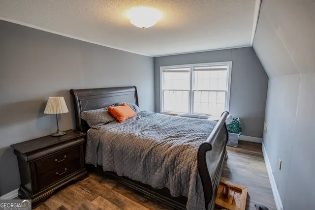 a bedroom with a bed and a chair