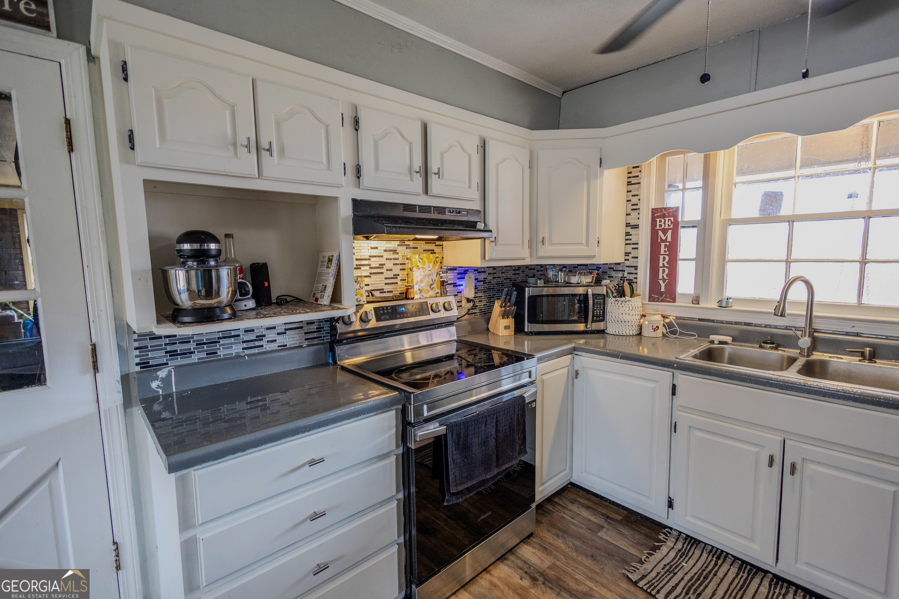 432 Airport Road Canon, GA 30520 - Photo 2 of 32 a kitchen with stainless steel appliances granite countertop a stove a sink and a white cabinets