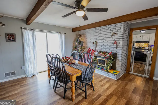 a view of a dining room with furniture and wooden floor