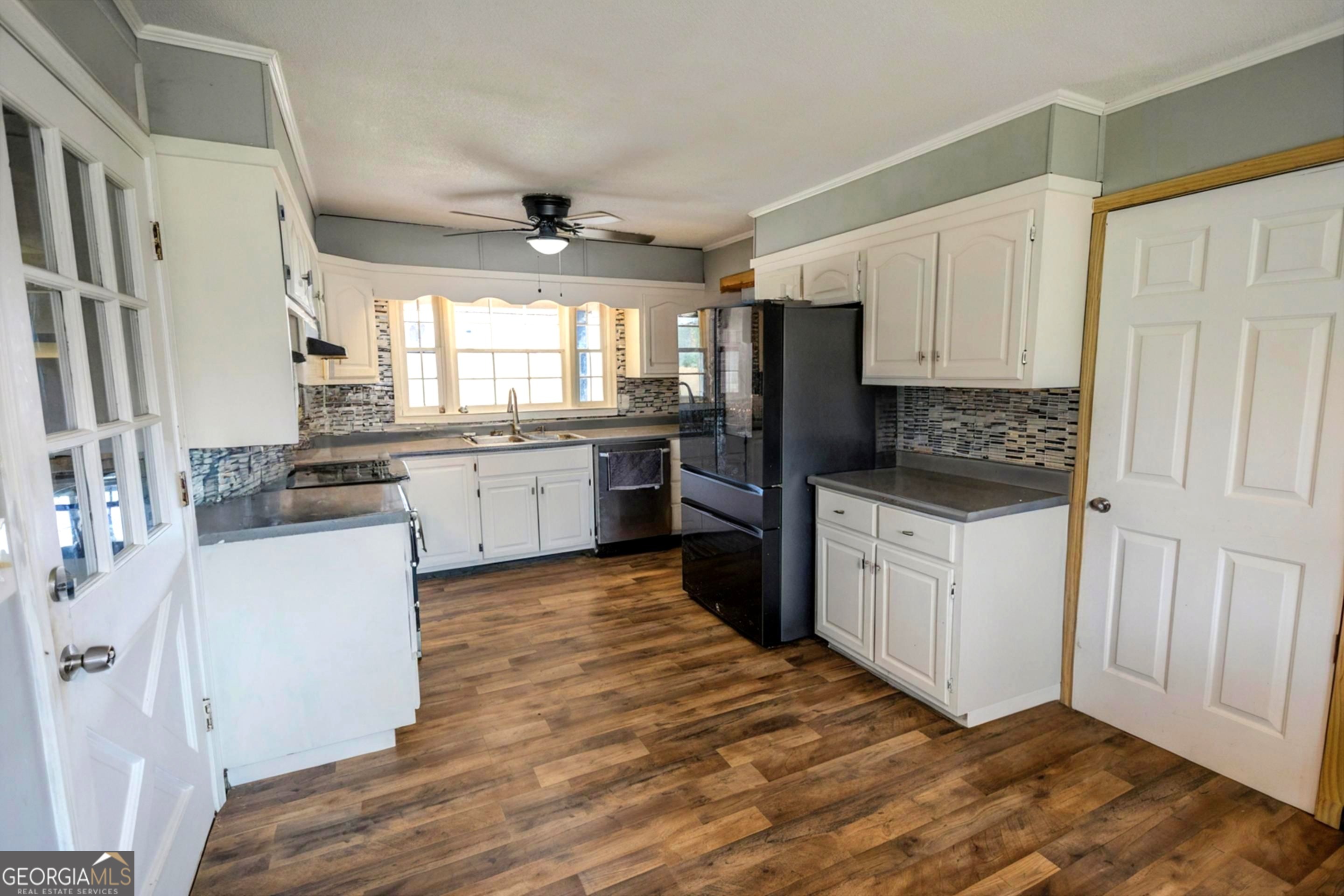 432 Airport Road Canon, GA 30520 - Photo 8 of 32 a kitchen with granite countertop white cabinets and white appliances