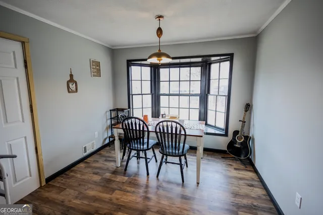 a view of a dining room with furniture and wooden floor