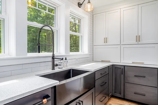 a kitchen with a sink and large window
