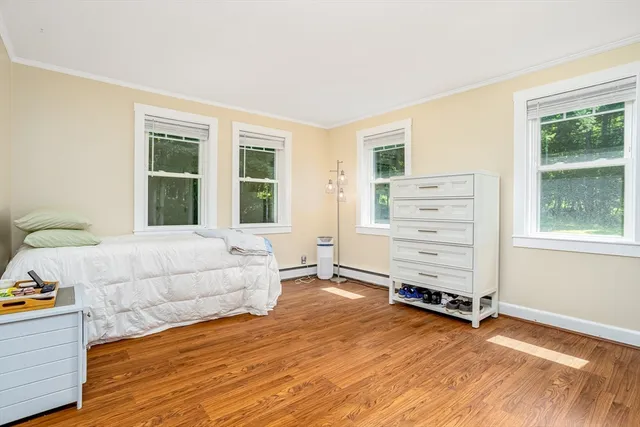 a spacious bedroom with a bed and a window