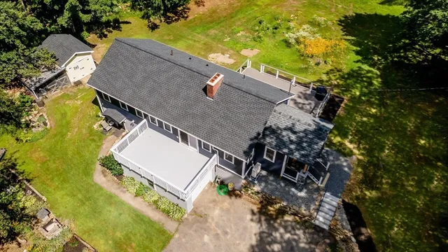 an aerial view of a house with a yard and trees