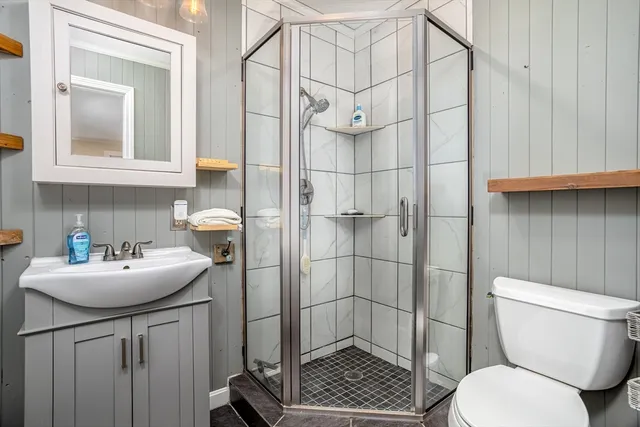 a bathroom with a sink toilet and shower