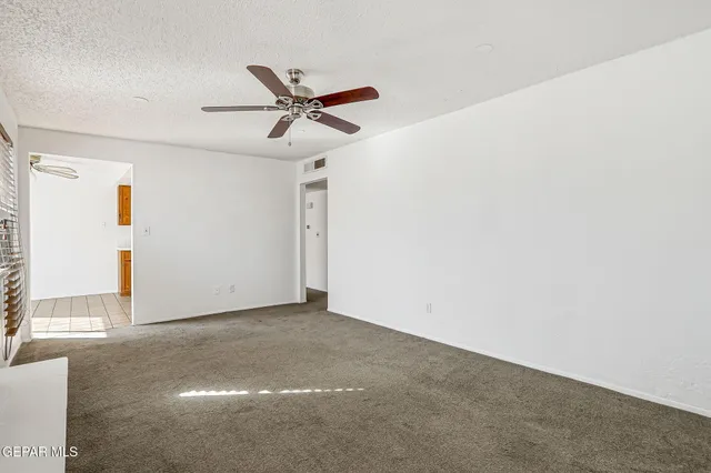 a view of a livingroom with a fireplace and a window