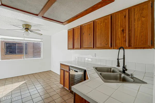 a kitchen with stainless steel appliances a stove a sink and a refrigerator