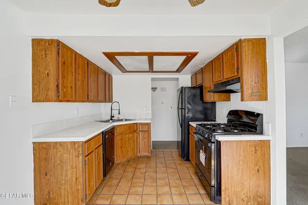 a kitchen with stainless steel appliances granite countertop a stove a sink and a refrigerator