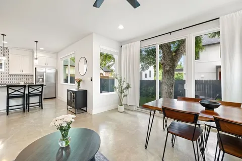 a living room with furniture and large windows
