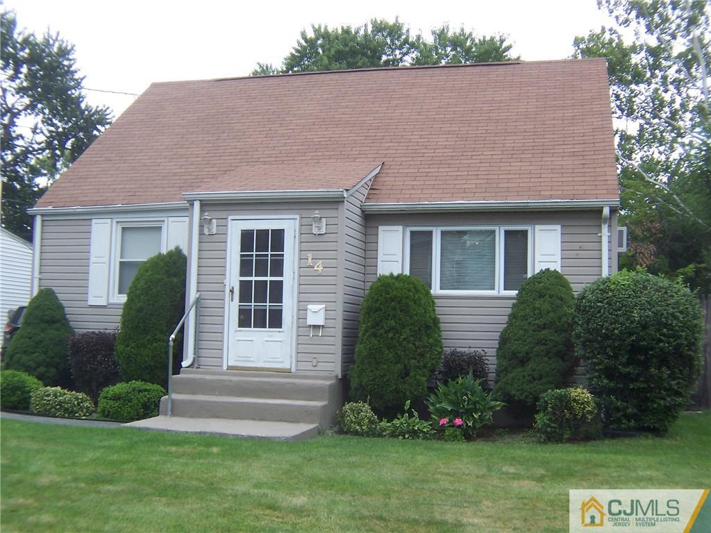 14 West Cliff Road Colonia, NJ 07067 - Photo 1 of 18 a front view of a house with a garden and plants