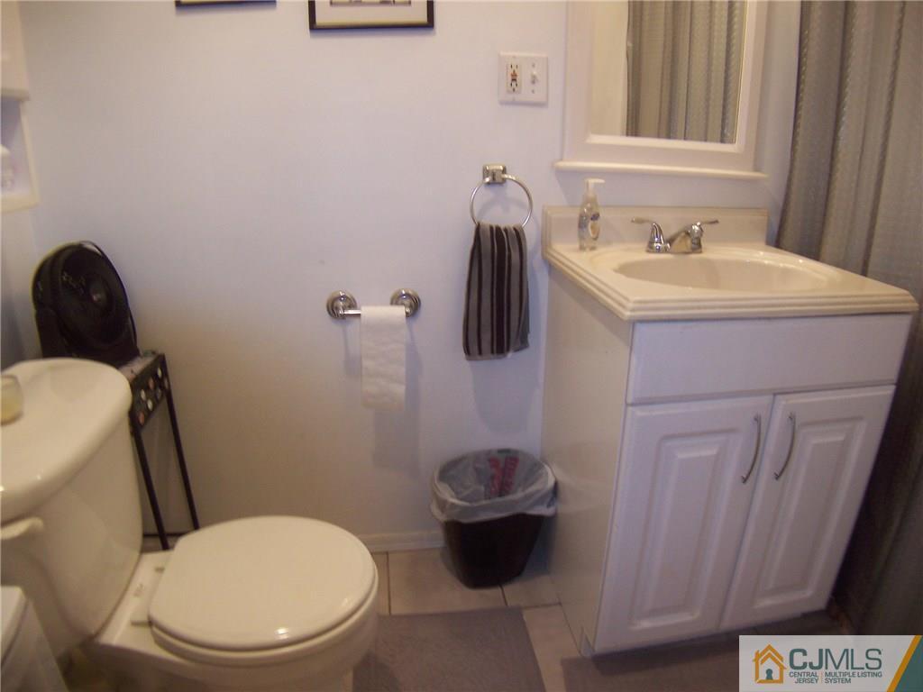 14 West Cliff Road Colonia, NJ 07067 - Photo 13 of 18 a bathroom with a toilet a sink and a mirror