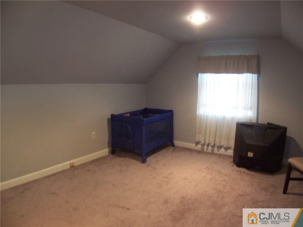 14 West Cliff Road Colonia, NJ 07067 - Photo 14 of 18 an empty room with windows and cabinet