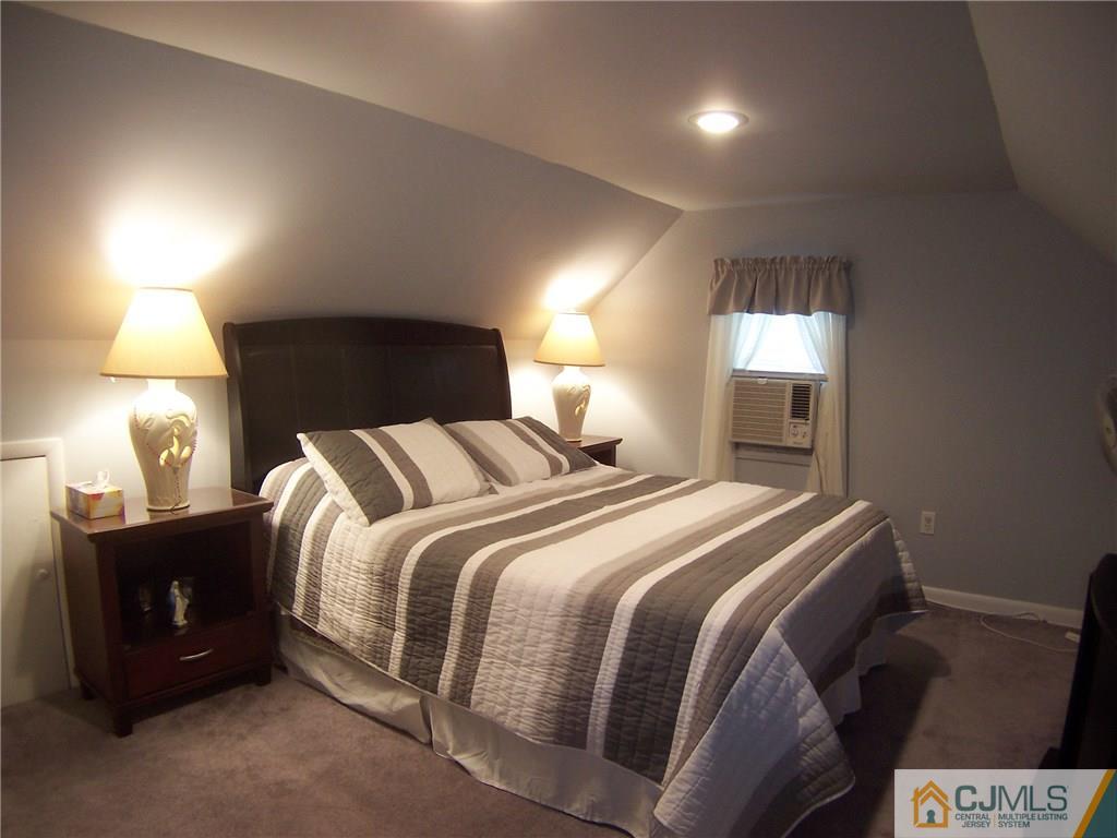 14 West Cliff Road Colonia, NJ 07067 - Photo 15 of 18 a bedroom with a bed and a lamp