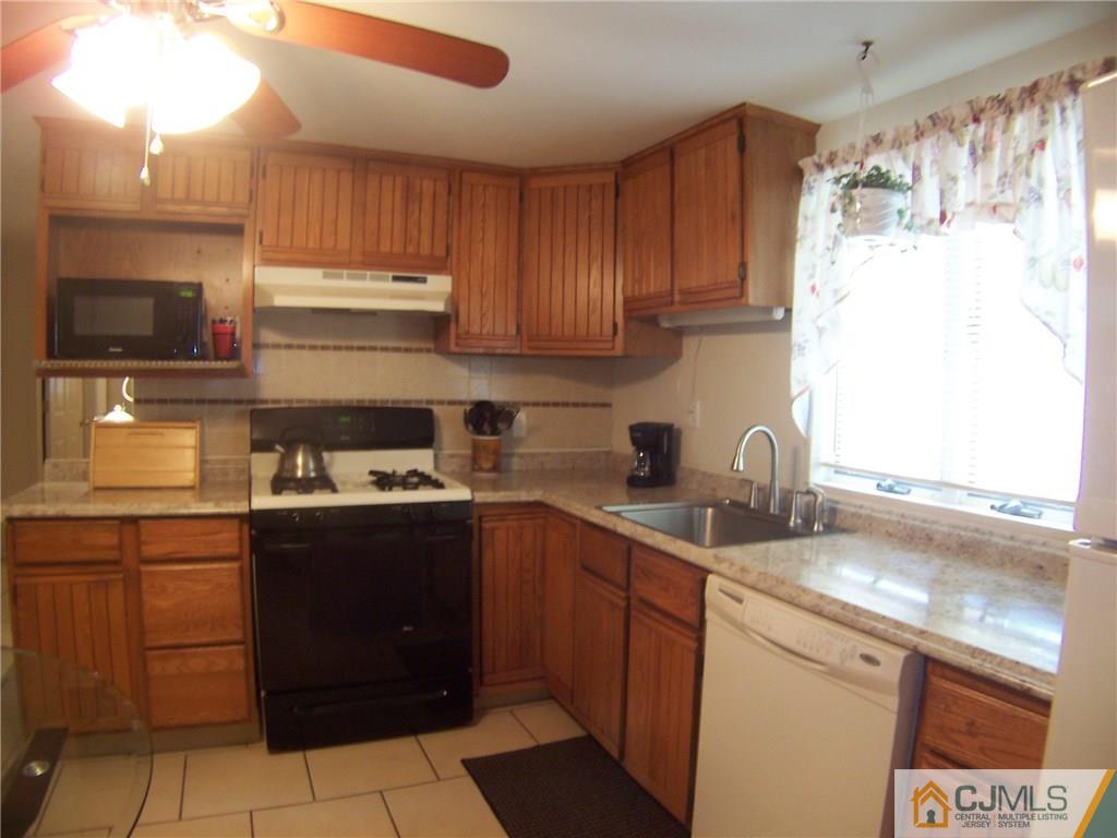 14 West Cliff Road Colonia, NJ 07067 - Photo 3 of 18 a kitchen with a sink stove and cabinets