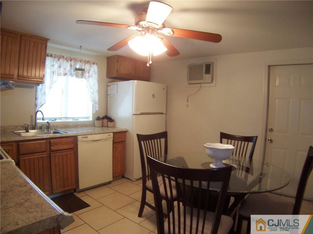 14 West Cliff Road Colonia, NJ 07067 - Photo 4 of 18 a kitchen with a dining table and chairs
