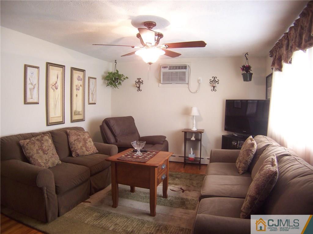 14 West Cliff Road Colonia, NJ 07067 - Photo 9 of 18 a living room with furniture and a flat screen tv