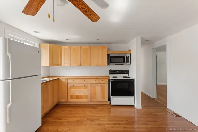 a kitchen with stainless steel appliances a refrigerator and a stove top oven