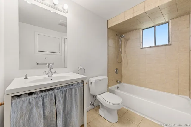 a bathroom with a sink a toilet and bathtub