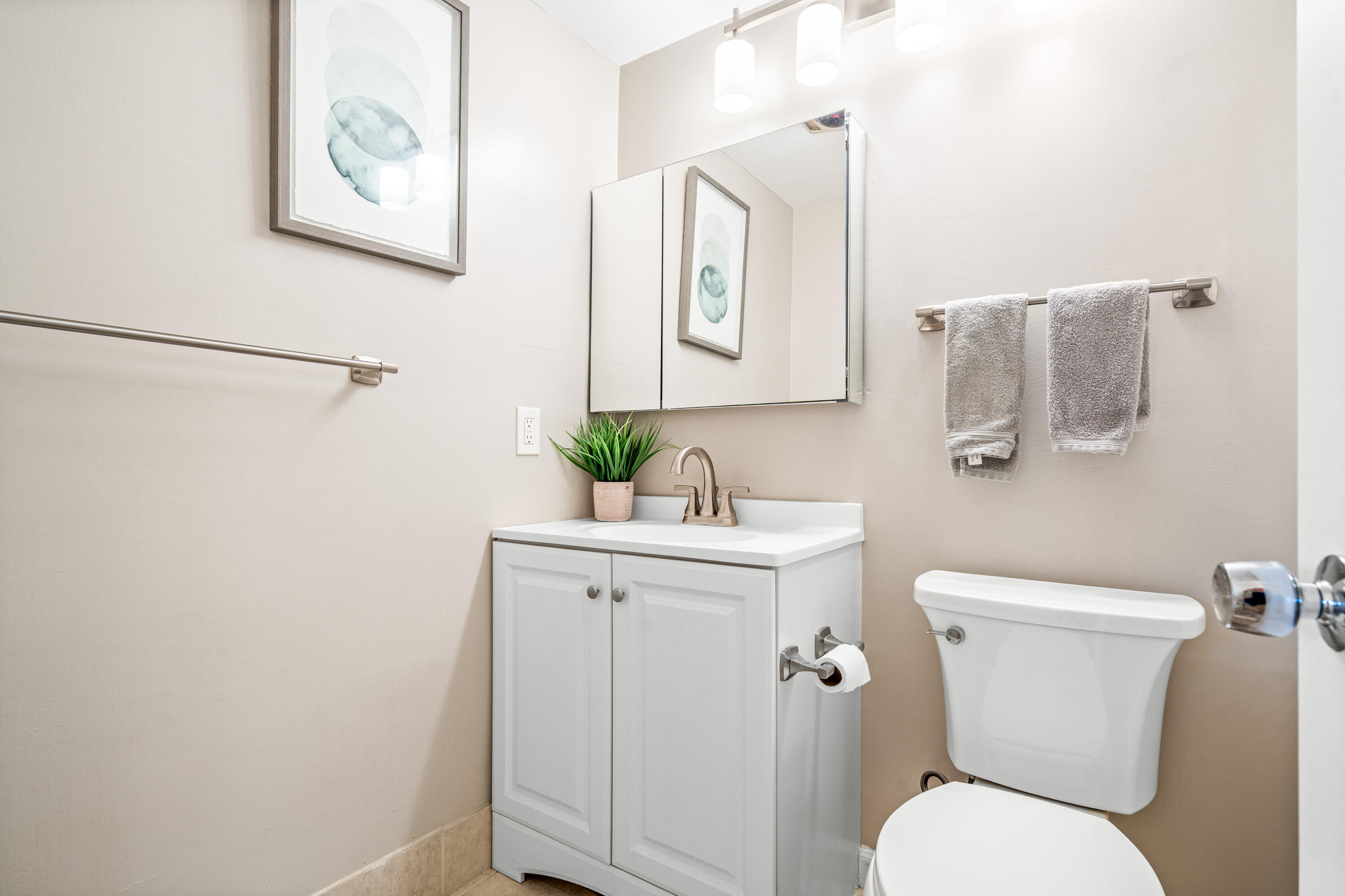 320 Horizon West, Unit 103 Boynton Beach, FL 33435 - Photo 15 of 24 a white toilet sitting next to a bathroom sink