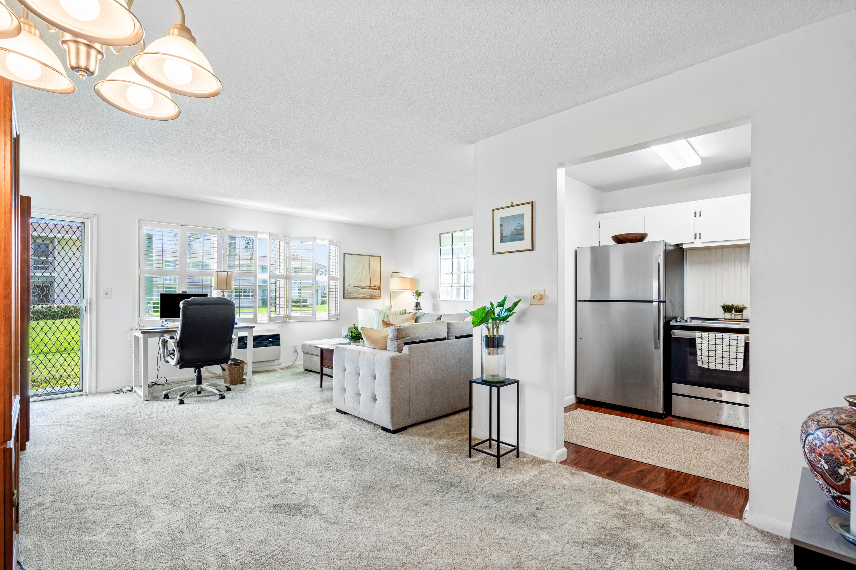 320 Horizon West, Unit 103 Boynton Beach, FL 33435 - Photo 10 of 24 a living room with furniture window and refrigerator