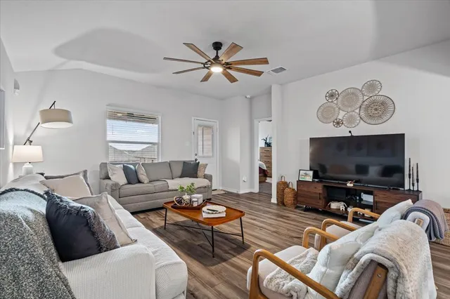 a living room with furniture and a flat screen tv