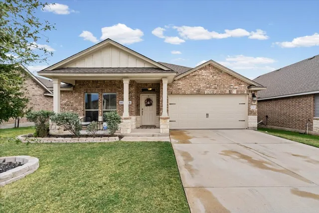 a front view of a house with a yard and porch