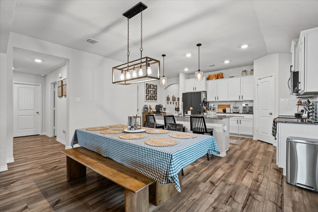 6326 Matagorda Road Belton, TX 76513 - Photo 6 of 14 a open kitchen with stainless steel appliances granite countertop a stove a refrigerator a kitchen island a sink and a wooden floors