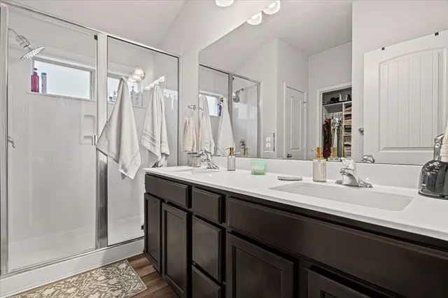 a bathroom with a double vanity sink mirror and double