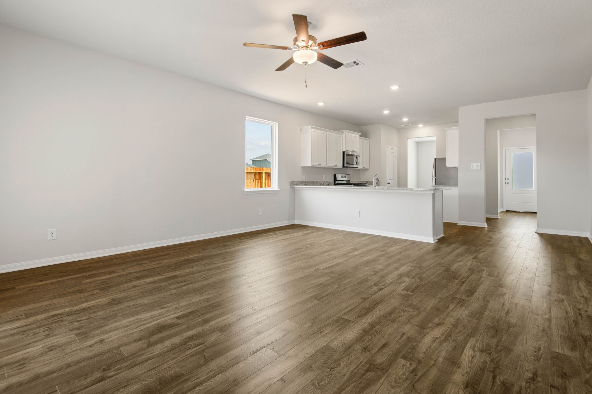708 Jasmine Ridge Lane Waller, TX 77484 - Photo 8 of 12 a view of empty room with wooden floor and fan