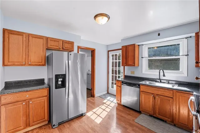 a kitchen with stainless steel appliances granite countertop a refrigerator and a sink